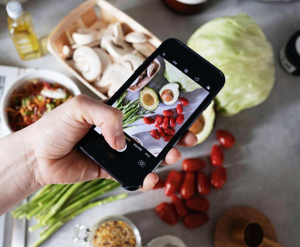 AI food tracking app on phone next to meal