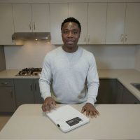 Man Using Kitchen Scale For Cooking